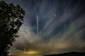 Stars and clouds across a deep night sky