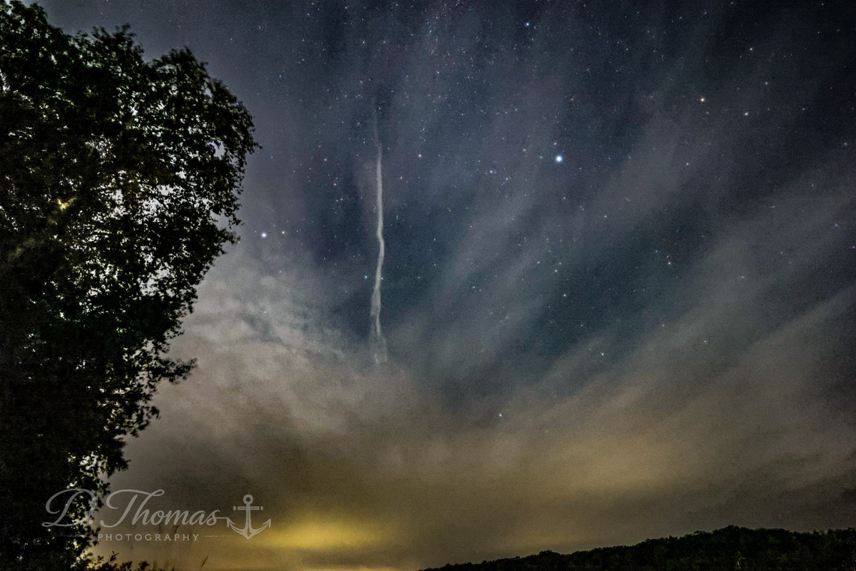 Stars and clouds across a deep night sky