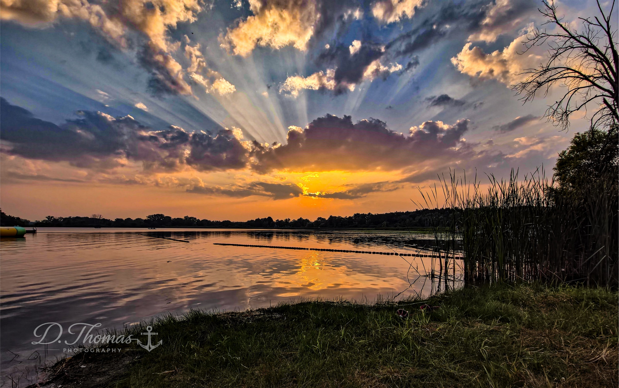 Sunset rays spreading across a calm lake