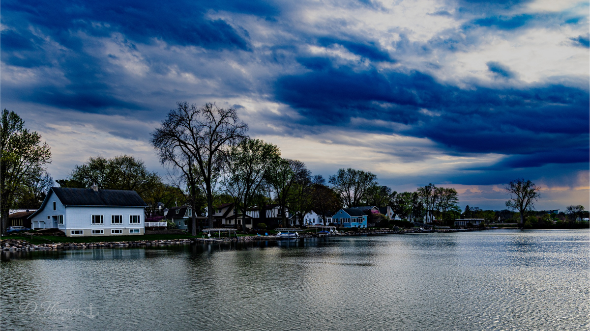 Lakeside homes under dramatic sky — D. Thomas Photography