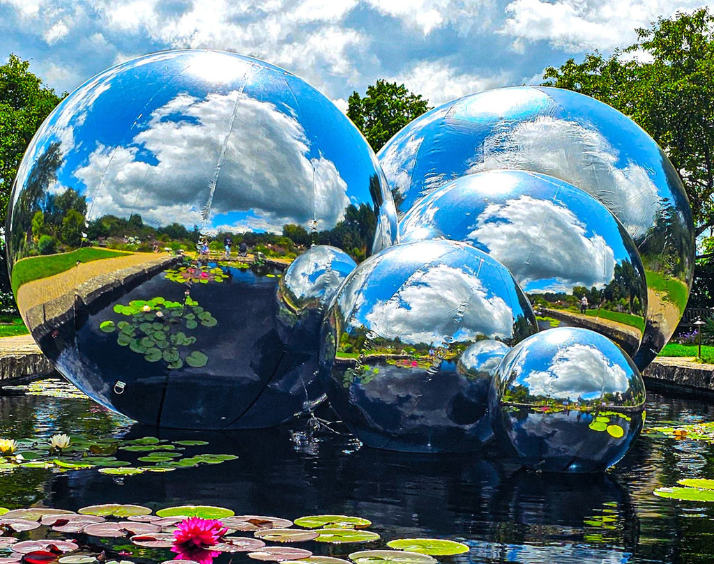 Skybound Reflections — mirrored spheres above a lily pond