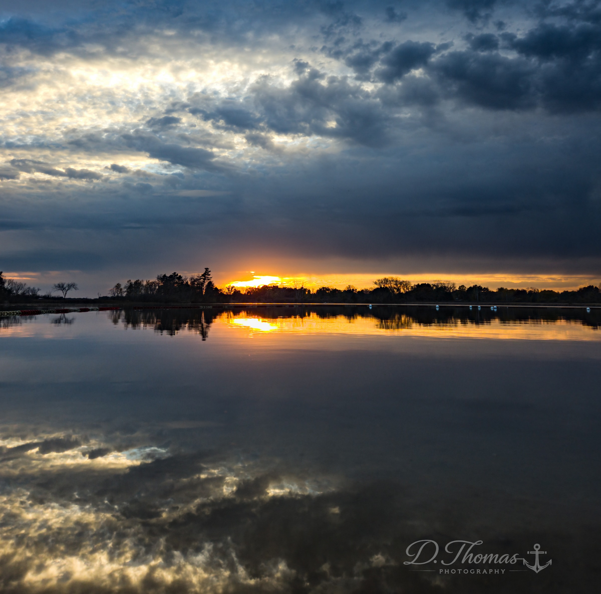Storm clouds and sunset reflected on lake — D. Thomas Photography